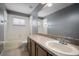 Bathroom showcasing ample vanity space, a shower/tub combo and neutral tiling at 11310 Callaway Pond Dr, Riverview, FL 33579