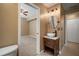 Cozy bathroom with a vessel sink on a wood vanity and view into the bedroom at 11310 Callaway Pond Dr, Riverview, FL 33579