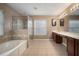 Primary bathroom features double sinks, a soaking tub, and a glass-enclosed shower at 11310 Callaway Pond Dr, Riverview, FL 33579