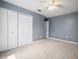 Bedroom with neutral carpeting, ceiling fan and an abundance of closet space at 11310 Callaway Pond Dr, Riverview, FL 33579