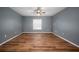 Modern bedroom with hardwood floors, a window, and gray walls at 11310 Callaway Pond Dr, Riverview, FL 33579