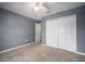This bedroom showcases carpeted flooring, closet, a ceiling fan and a door leading to other rooms at 11310 Callaway Pond Dr, Riverview, FL 33579