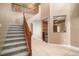 Grand foyer with a staircase, tile flooring, and view to the wine storage area at 11310 Callaway Pond Dr, Riverview, FL 33579