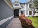Inviting walkway to a screened front door surrounded by fresh landscaping and a manicured lawn at 11310 Callaway Pond Dr, Riverview, FL 33579