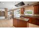 Open kitchen layout with a center island, tiled floors, and sliding glass doors leading to the pool at 11310 Callaway Pond Dr, Riverview, FL 33579