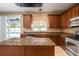 A kitchen with granite counters, stainless steel appliances, island and access to the pool at 11310 Callaway Pond Dr, Riverview, FL 33579