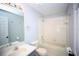 Traditional bathroom with white fixtures, vanity, and tub with shower at 11618 Colony Lake Dr, Tampa, FL 33635