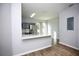 Modern kitchen featuring stainless steel appliances, sleek gray cabinets, white quartz countertop, and light wood floors at 11618 Colony Lake Dr, Tampa, FL 33635