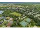 Aerial view capturing community with park, tennis courts, and green spaces amidst residential homes at 12335 Silton Peace Dr, Riverview, FL 33579