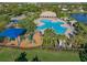 Aerial of a clover-shaped community pool, playground and gathering spaces, perfect for relaxation and fun in a friendly neighborhood at 12335 Silton Peace Dr, Riverview, FL 33579