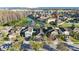 Aerial view of the neighborhood and surrounding area, highlighting the lush landscape and nearby lakes at 12523 Longstone Ct, New Port Richey, FL 34655