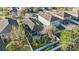 An aerial view of a landscaped property showcasing a well-maintained lawn, trees, and a white fenced boundary at 12523 Longstone Ct, New Port Richey, FL 34655