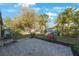 The backyard features a brick patio and lush landscaping with beautiful trees and flowering plants at 12523 Longstone Ct, New Port Richey, FL 34655