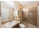 Bathroom featuring a shower with glass doors, vanity, and tile surround at 12523 Longstone Ct, New Port Richey, FL 34655