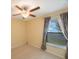 Bedroom with carpet, ceiling fan, and window with curtains at 12523 Longstone Ct, New Port Richey, FL 34655