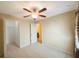 Bedroom with carpet and ceiling fan and attached walk-in closet and bathroom at 12523 Longstone Ct, New Port Richey, FL 34655