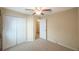 Bedroom with carpet, ceiling fan, and closet at 12523 Longstone Ct, New Port Richey, FL 34655