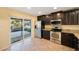 Kitchen featuring stainless steel appliances, dark cabinetry, and tile flooring at 12523 Longstone Ct, New Port Richey, FL 34655