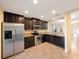 Well-equipped kitchen with stainless steel appliances, granite countertops, and dark wood cabinets at 12523 Longstone Ct, New Port Richey, FL 34655