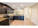 Spacious kitchen boasts stainless steel appliances, granite counters, and dark wood cabinetry at 12523 Longstone Ct, New Port Richey, FL 34655