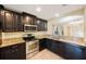 Modern kitchen with stainless steel appliances, granite countertops, and ample cabinet space at 12523 Longstone Ct, New Port Richey, FL 34655