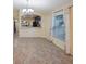 Sunny living area boasting ceramic tile floors, decorative chandelier, and large window at 12523 Longstone Ct, New Port Richey, FL 34655