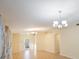 Bright and airy living area with ceramic tile flooring, neutral paint, large windows, and chandelier lighting at 12523 Longstone Ct, New Port Richey, FL 34655