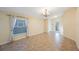 Bright, open living space featuring tile flooring, a large window, and a decorative glass front door at 12523 Longstone Ct, New Port Richey, FL 34655