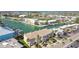 Aerial view of townhomes on the water with private docks and a nearby community pool at 156 117Th Ave, Treasure Island, FL 33706