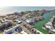 An aerial view of a beachfront community with vibrant properties, marina access, and lovely ocean views at 156 117Th Ave, Treasure Island, FL 33706