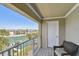 Private balcony overlooking a canal and palm trees is perfect for relaxation and outdoor enjoyment at 156 117Th Ave, Treasure Island, FL 33706