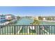 Balcony with panoramic view of waterfront and docks offers a tranquil outdoor experience at 156 117Th Ave, Treasure Island, FL 33706