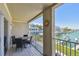 This balcony features outdoor seating and scenic waterfront views at 156 117Th Ave, Treasure Island, FL 33706