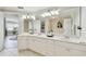 Well-lit bathroom features double vanity, quartz counters, and tile floors at 156 117Th Ave, Treasure Island, FL 33706