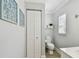 Cozy powder room with custom paint, a toilet and pedestal sink features charming details at 156 117Th Ave, Treasure Island, FL 33706