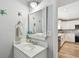 Updated powder room with turtle decorations, a mirror, a vanity, and a view to the kitchen at 156 117Th Ave, Treasure Island, FL 33706