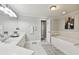 Well-lit bathroom features a soaking tub, walk-in shower, and double vanity at 156 117Th Ave, Treasure Island, FL 33706