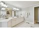 Well-lit bathroom features double vanity, quartz counters, and tile floors at 156 117Th Ave, Treasure Island, FL 33706