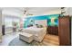 Comfortable bedroom features a tufted headboard, accent wall, and a large window at 156 117Th Ave, Treasure Island, FL 33706