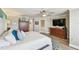 Bright bedroom features wood floors, a ceiling fan, and access to bathroom at 156 117Th Ave, Treasure Island, FL 33706