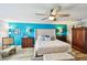 Comfortable bedroom features a tufted headboard, accent wall, and wood floors at 156 117Th Ave, Treasure Island, FL 33706
