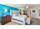 Bright bedroom features a tufted headboard, accent wall, and wood floors at 156 117Th Ave, Treasure Island, FL 33706
