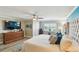 Bright bedroom features wood floors, a ceiling fan, and a view of water at 156 117Th Ave, Treasure Island, FL 33706
