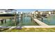 View of a boat dock with multiple boat lifts over the water at 156 117Th Ave, Treasure Island, FL 33706