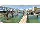 Boat dock with boat lifts offering direct water access and scenic views at 156 117Th Ave, Treasure Island, FL 33706