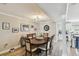 Dining room features wood flooring, elegant lighting, and seating for six near the updated kitchen at 156 117Th Ave, Treasure Island, FL 33706