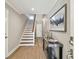 Stylish entryway featuring a staircase, console table with decor, and hardwood flooring at 156 117Th Ave, Treasure Island, FL 33706