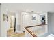 Bright hallway with wood floors leads to bathroom and bedroom at 156 117Th Ave, Treasure Island, FL 33706