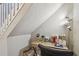 Cozy home office nook with a desk, lamp, and organized storage space beneath the stairs at 156 117Th Ave, Treasure Island, FL 33706
