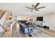 Spacious open-concept living room with hardwood floors, modern furnishings, and staircase access at 156 117Th Ave, Treasure Island, FL 33706